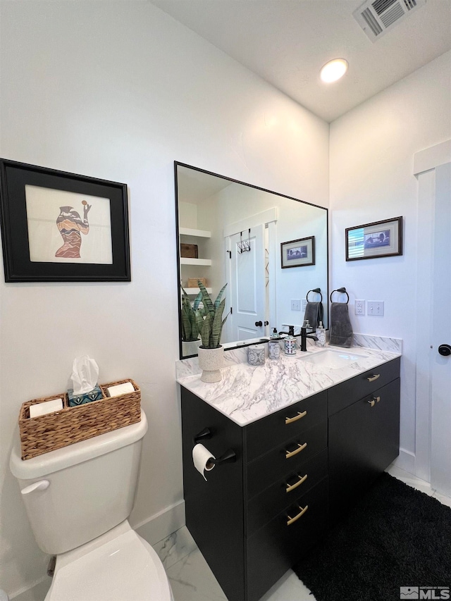 bathroom featuring toilet and vanity