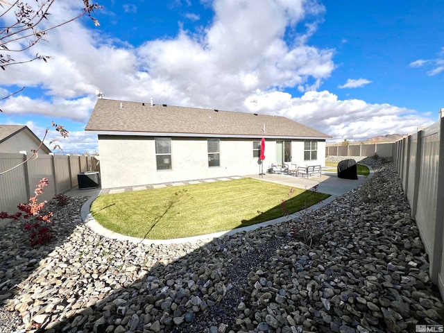 back of property featuring central air condition unit, a patio area, and a yard