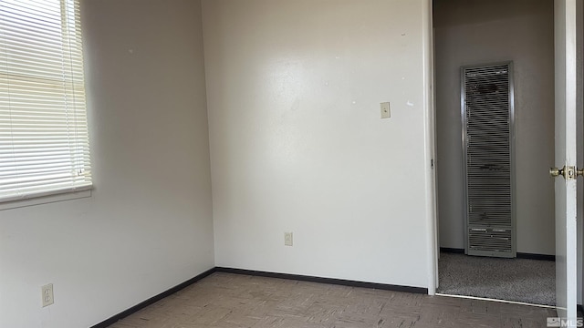 interior space featuring a heating unit and baseboards