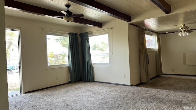 carpeted empty room with a ceiling fan and a wealth of natural light