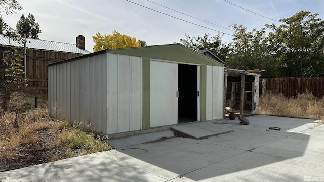 view of shed with fence