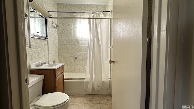 full bath featuring vanity, tile patterned flooring, toilet, and shower / bathtub combination with curtain