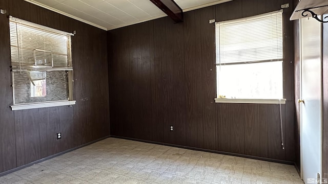 spare room with light floors and wood walls