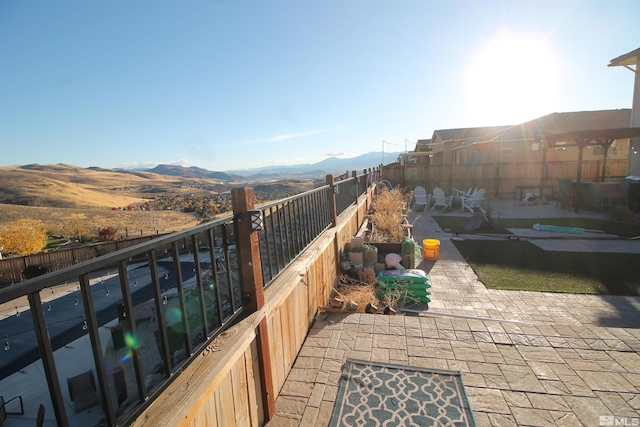 view of patio featuring a mountain view and a pool