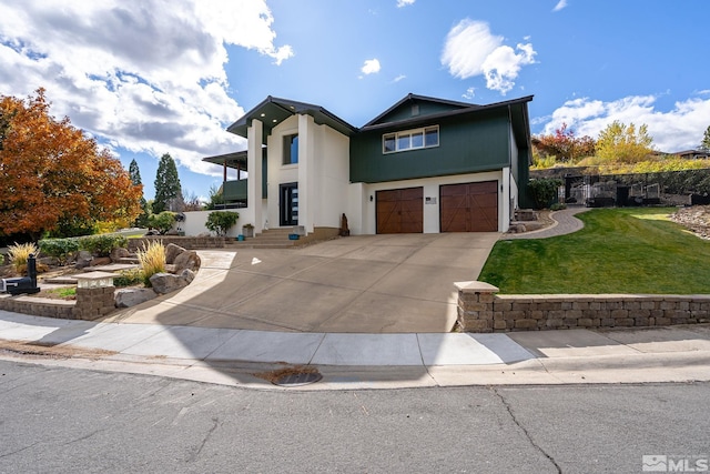 view of front of house with a front yard and a garage