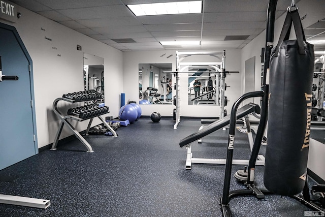 exercise room with a paneled ceiling