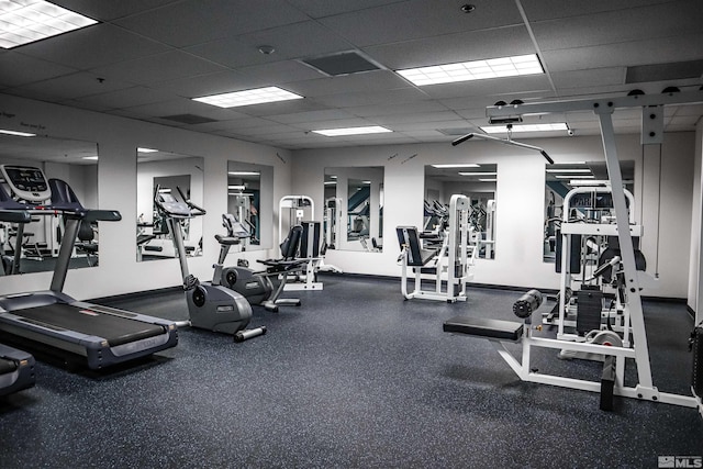 exercise room featuring a drop ceiling