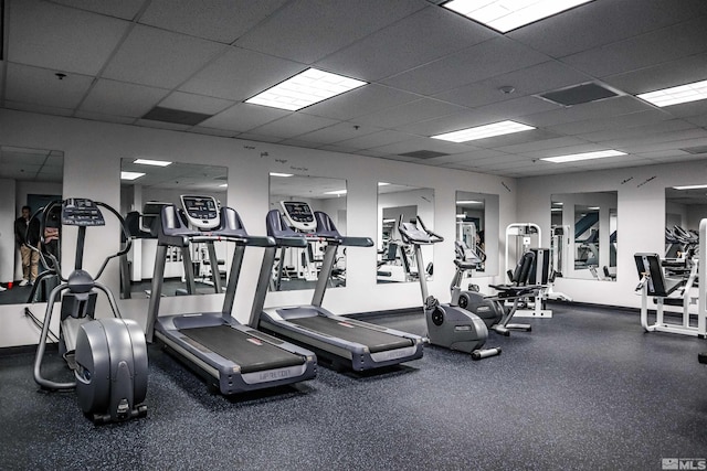 workout area featuring a drop ceiling