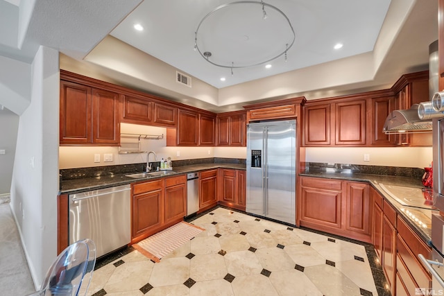 kitchen featuring sink, appliances with stainless steel finishes, and dark stone counters