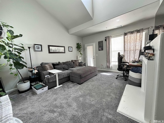 carpeted living room with vaulted ceiling