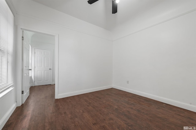 empty room with ceiling fan and dark hardwood / wood-style floors