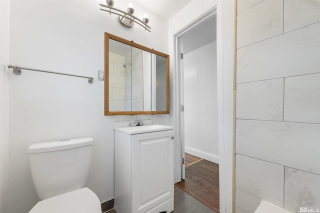 bathroom featuring vanity, toilet, and hardwood / wood-style flooring