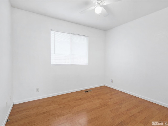 spare room with light hardwood / wood-style flooring and ceiling fan