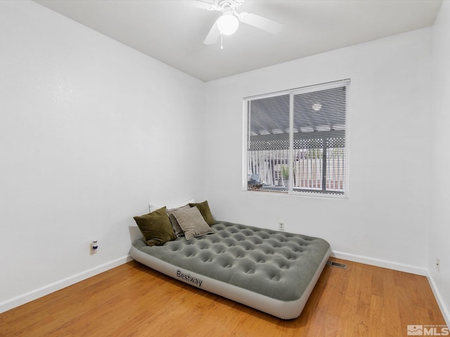 bedroom with hardwood / wood-style floors and ceiling fan