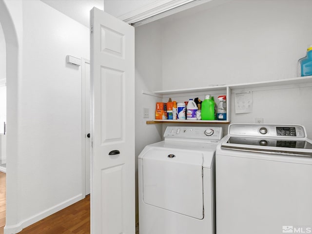 washroom featuring dark wood-type flooring and washer and clothes dryer