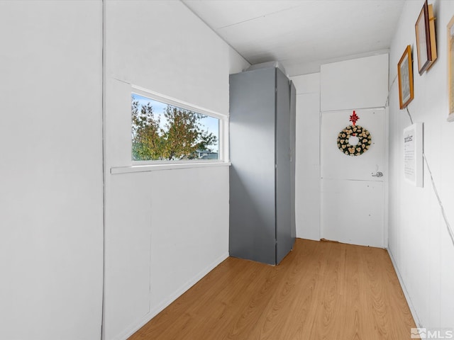 hallway with light hardwood / wood-style flooring