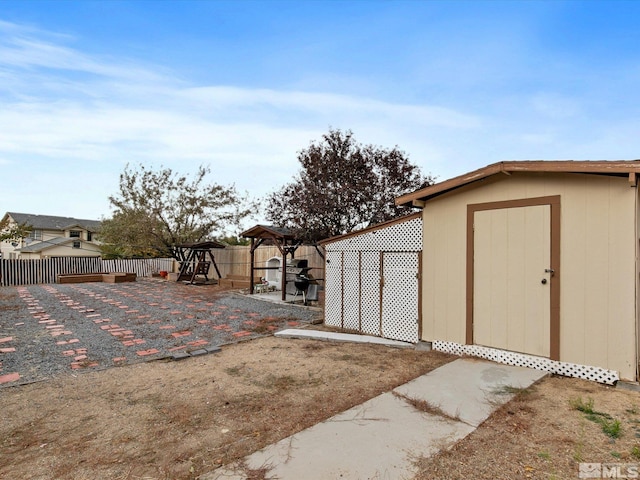 view of yard featuring a storage unit and a patio