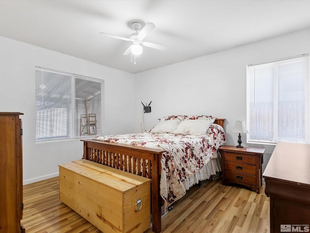 bedroom with light hardwood / wood-style floors and ceiling fan