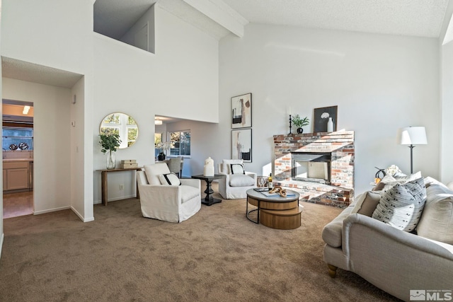 carpeted living room featuring beam ceiling, a fireplace, and high vaulted ceiling