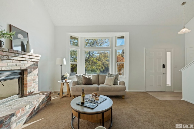 living room with light carpet, a textured ceiling, and a fireplace