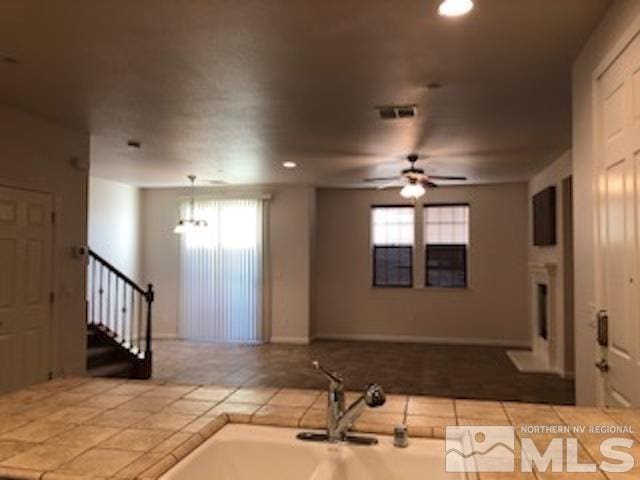 kitchen featuring tile patterned floors, sink, decorative light fixtures, and ceiling fan