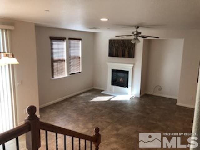 unfurnished living room with ceiling fan