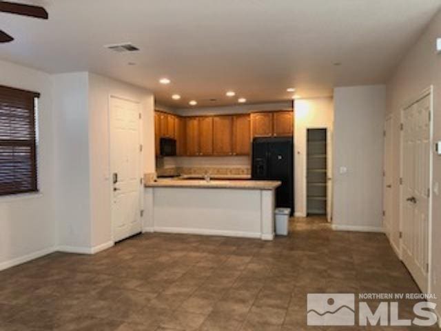 kitchen featuring black appliances, kitchen peninsula, and ceiling fan