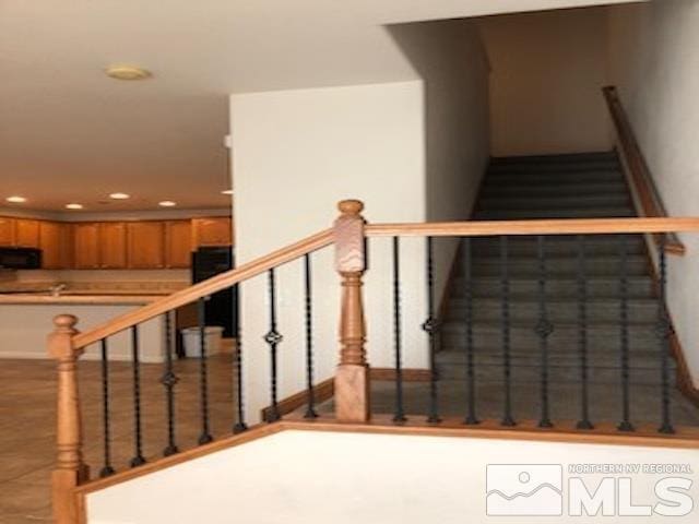 staircase featuring tile patterned floors