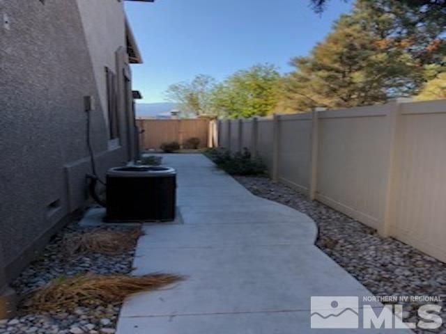 exterior space with cooling unit and a patio area