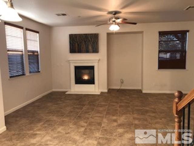 unfurnished living room with ceiling fan