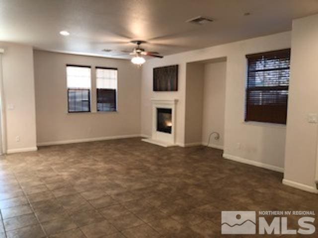 unfurnished living room featuring ceiling fan