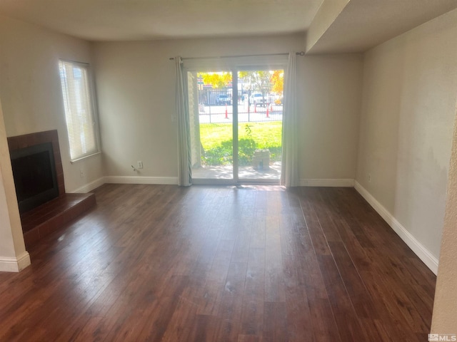 unfurnished living room featuring dark hardwood / wood-style floors