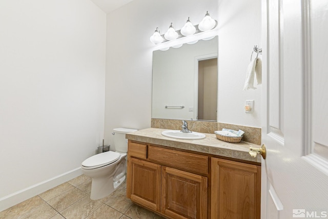 bathroom with vanity, tile patterned floors, and toilet