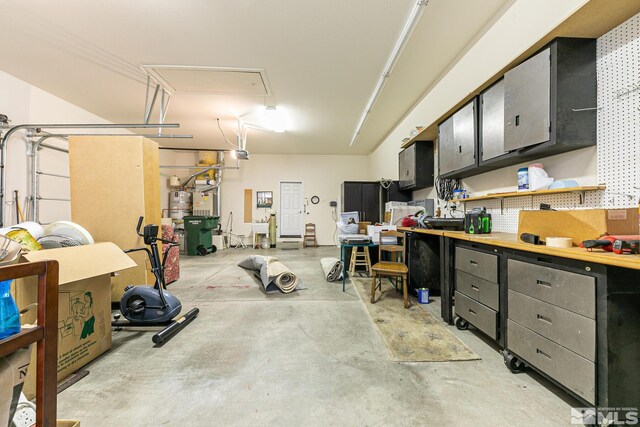 garage featuring a garage door opener and strapped water heater