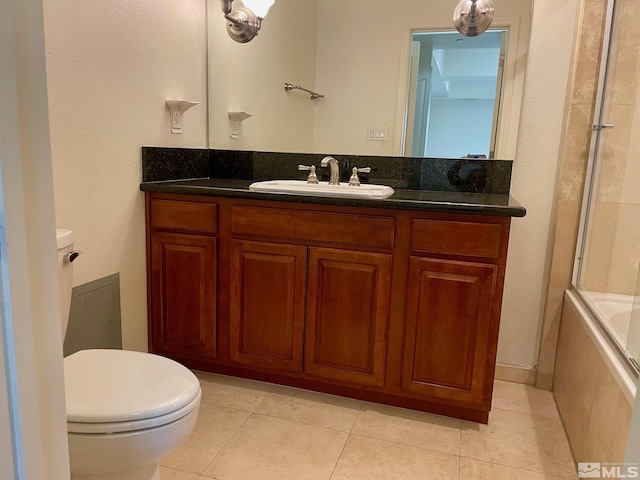 full bathroom with toilet, vanity, tile patterned floors, and shower / bath combination with glass door