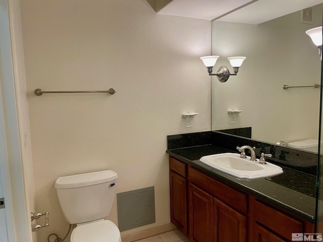 bathroom featuring tile patterned flooring, vanity, and toilet