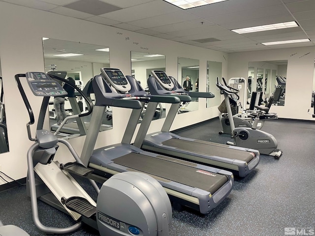 exercise room featuring a drop ceiling