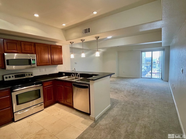 kitchen featuring light carpet, sink, stainless steel appliances, and decorative light fixtures