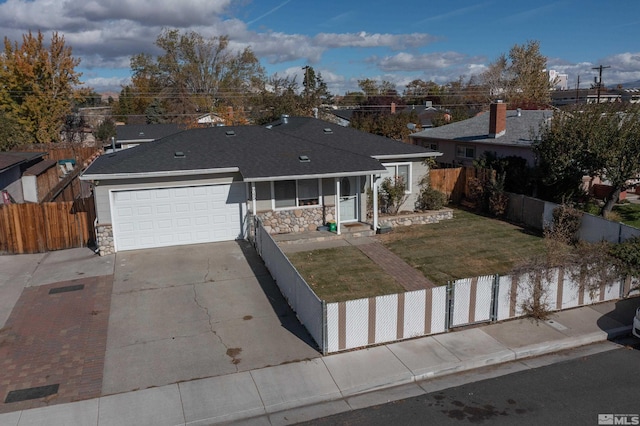 ranch-style home featuring a garage and a front lawn