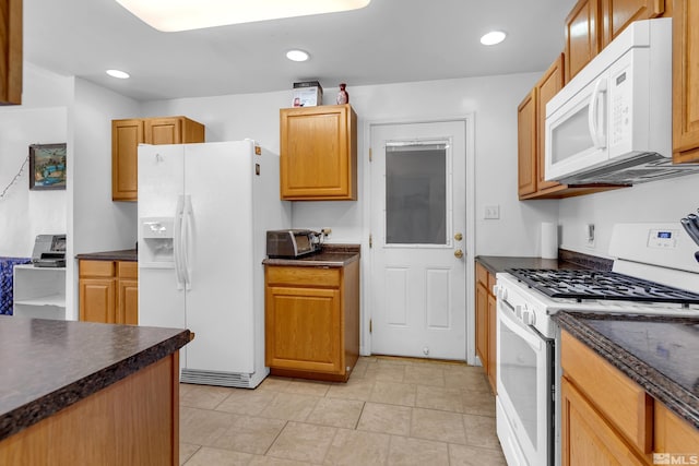 kitchen with white appliances and light tile patterned flooring