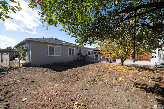 rear view of house featuring a patio area and central AC