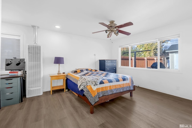 bedroom with ceiling fan and dark hardwood / wood-style flooring