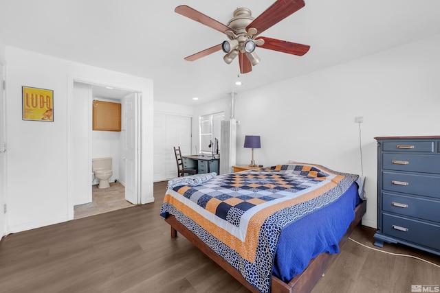 bedroom featuring connected bathroom, ceiling fan, and dark hardwood / wood-style flooring