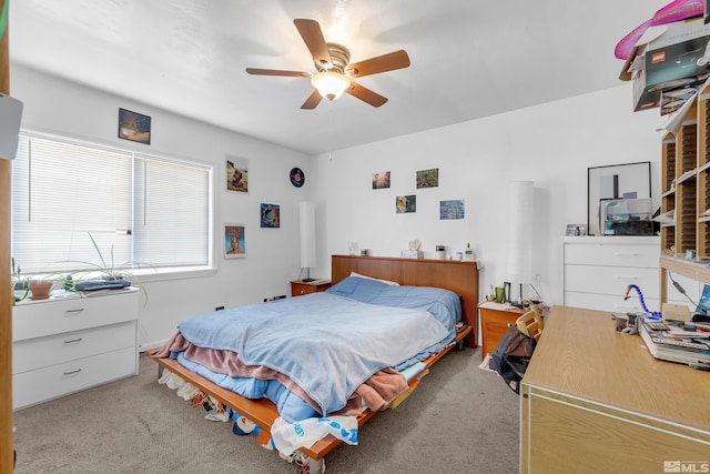 bedroom with light colored carpet and ceiling fan