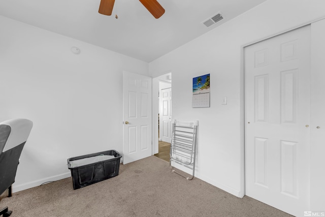 interior space with ceiling fan and carpet