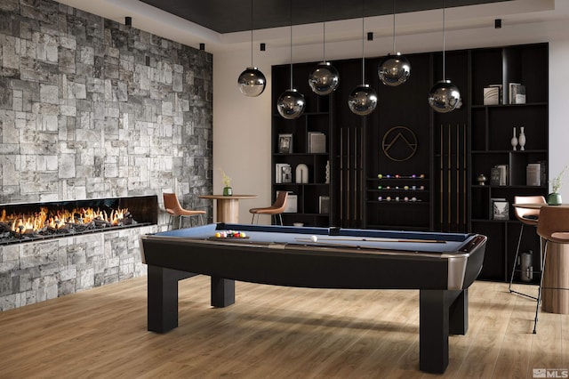 playroom featuring hardwood / wood-style floors, pool table, and a fireplace