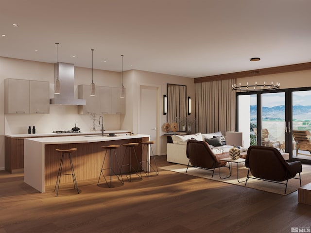 kitchen featuring a breakfast bar, a center island with sink, dark hardwood / wood-style flooring, wall chimney range hood, and white cabinets