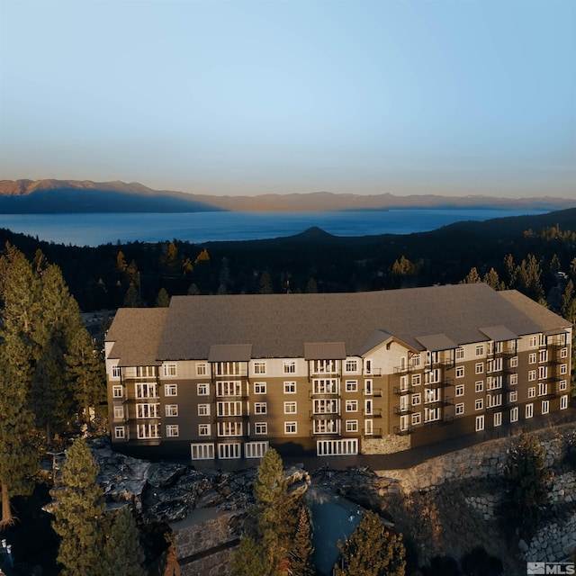 exterior space with a water and mountain view