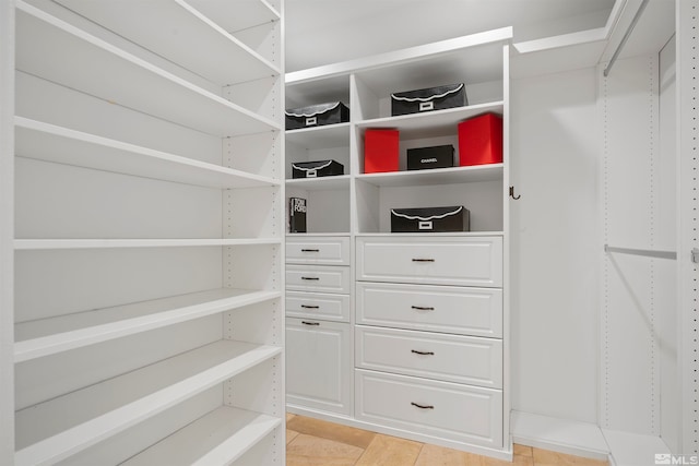 spacious closet featuring light tile patterned floors