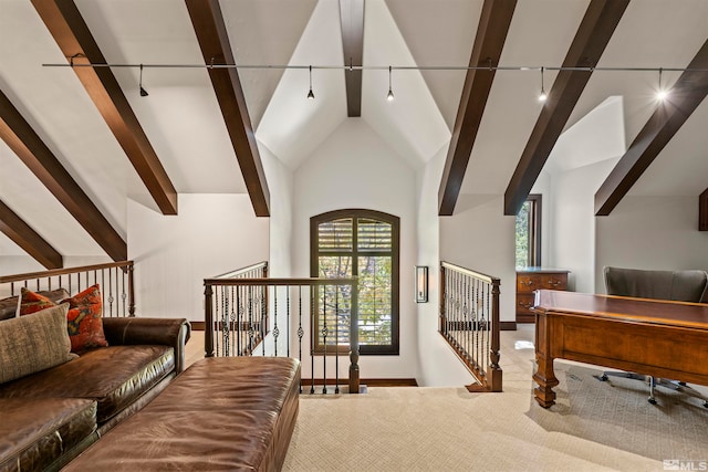 interior space with rail lighting, high vaulted ceiling, carpet flooring, and beamed ceiling